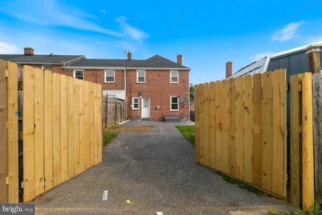 1317 Winston Ave, Baltimore, MD 21239 - view of property exterior with a patio and brick siding
