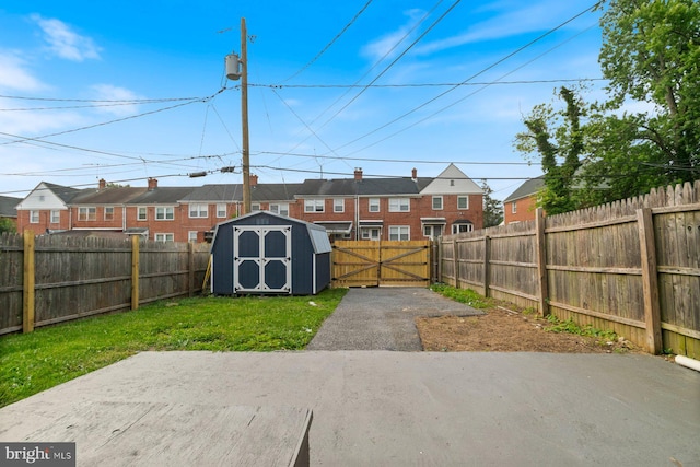 1317 Winston Ave, Baltimore, MD 21239 - fenced backyard featuring a residential view, a storage unit, a patio, and a gate