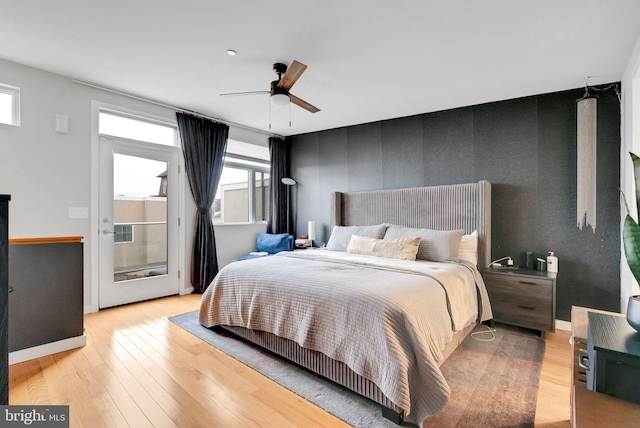 211 Brown St Unit 15, Philadelphia, PA 19123 - bedroom featuring multiple windows, light wood-style flooring, and an accent wall