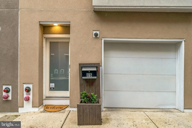 211 Brown St Unit 15, Philadelphia, PA 19123 - property entrance with stucco siding and a garage
