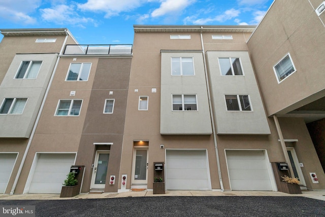 211 Brown St Unit 15, Philadelphia, PA 19123 - view of building exterior with a garage