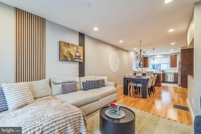 211 Brown St Unit 15, Philadelphia, PA 19123 - living area with light wood-style floors, recessed lighting, baseboards, and a chandelier