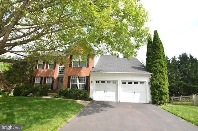 6385 Hunters Crossing Ct, Eldersburg, MD 21784 - colonial home with an attached garage, asphalt driveway, and brick siding