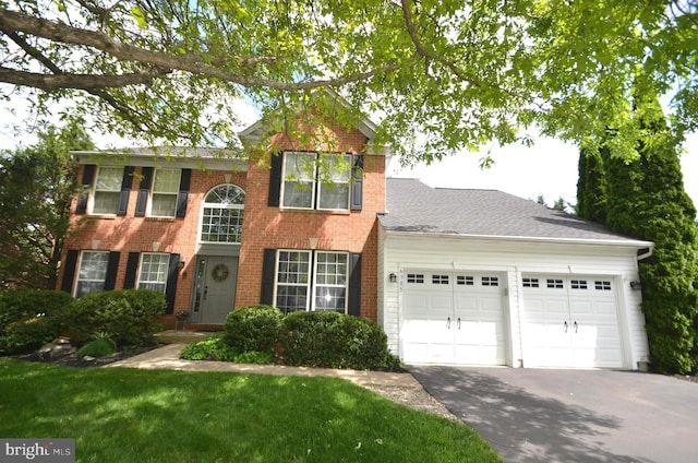 6385 Hunters Crossing Ct, Eldersburg, MD 21784 - colonial inspired home featuring an attached garage, driveway, brick siding, and a front lawn