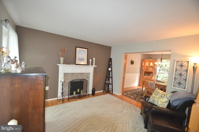 6385 Hunters Crossing Ct, Eldersburg, MD 21784 - living area with wood finished floors, a chandelier, a tile fireplace, and baseboards