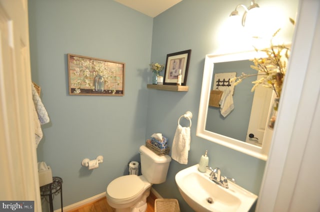6385 Hunters Crossing Ct, Eldersburg, MD 21784 - half bathroom featuring a sink, toilet, and wood finished floors