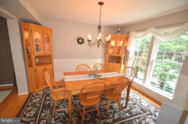 6385 Hunters Crossing Ct, Eldersburg, MD 21784 - dining area with a chandelier, wood finished floors, and wainscoting