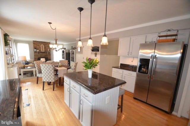 6385 Hunters Crossing Ct, Eldersburg, MD 21784 - kitchen with stainless steel fridge, white cabinets, light wood-type flooring, a center island, and hanging light fixtures