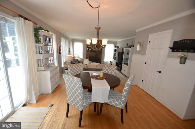 6385 Hunters Crossing Ct, Eldersburg, MD 21784 - dining space featuring a chandelier, light wood-type flooring, and wainscoting