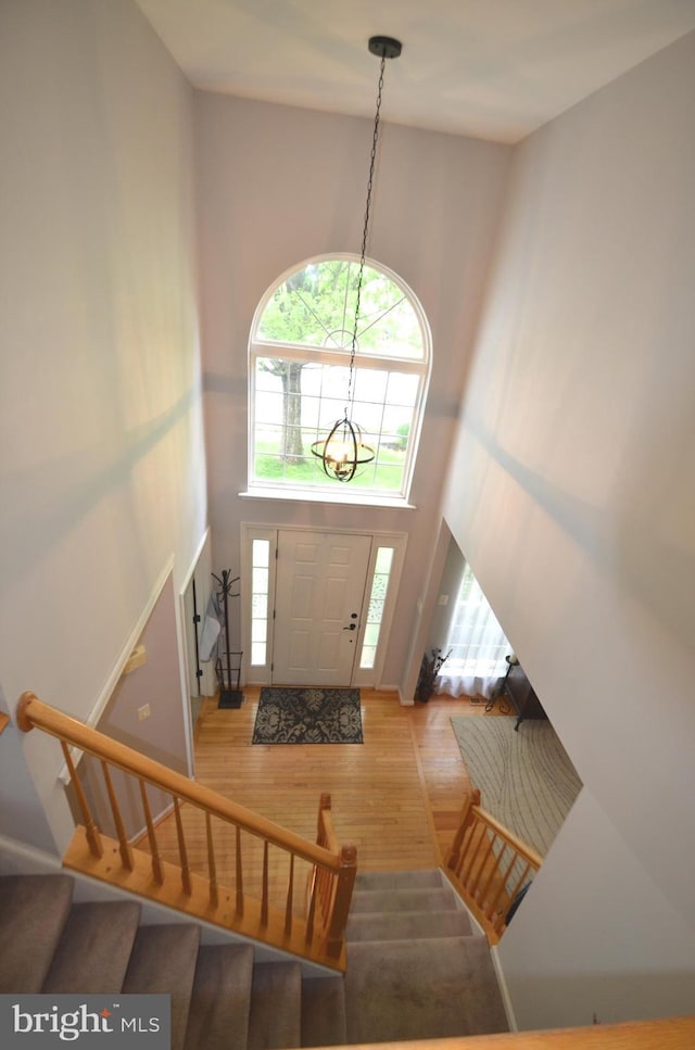 6385 Hunters Crossing Ct, Eldersburg, MD 21784 - foyer with stairs, wood finished floors, a high ceiling, and a chandelier