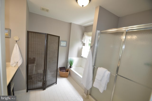 6385 Hunters Crossing Ct, Eldersburg, MD 21784 - bathroom featuring a garden tub, a shower stall, and tile patterned flooring