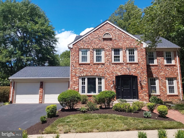 9200 Dorothy Ln, Springfield, VA 22153 - view of front of property featuring brick siding, driveway, an attached garage, and roof with shingles