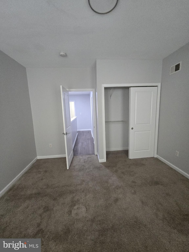 524 N Patterson Park Ave N, Baltimore, MD 21205 - unfurnished bedroom featuring carpet floors, baseboards, and a closet