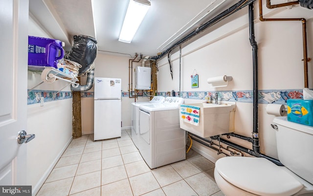 39 Kentucky Dr, Little Egg Harbor Twp, NJ 08087 - washroom with separate washer and dryer, light tile patterned flooring, water heater, and baseboards