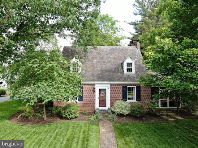 1598 Hollywood Dr, Lancaster, PA 17601 - cape cod-style house featuring a front yard, brick siding, and a chimney