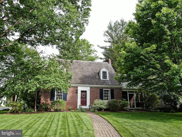 1598 Hollywood Dr, Lancaster, PA 17601 - cape cod-style house featuring brick siding, a front yard, and a chimney