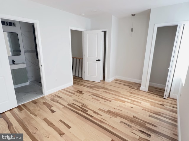 2015 S 23rd St, Philadelphia, PA 19145 - unfurnished bedroom with light wood-style floors, baseboards, and ensuite bath