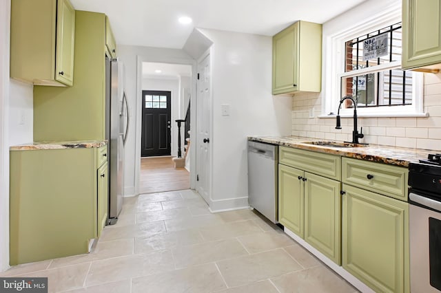 4504 Clay St NE, Washington, DC 20019 - kitchen featuring appliances with stainless steel finishes, green cabinets, a sink, recessed lighting, and decorative backsplash