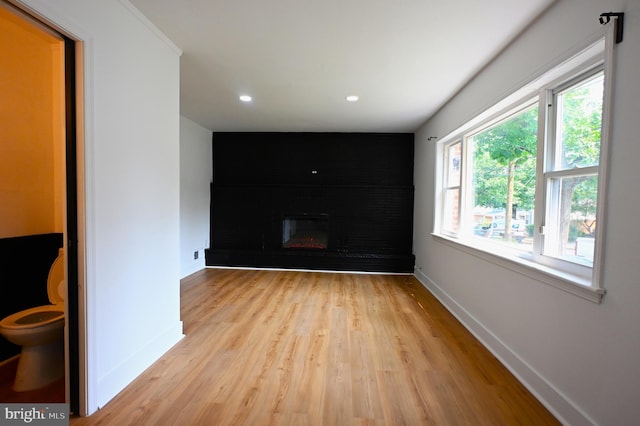 4504 Clay St NE, Washington, DC 20019 - spare room featuring baseboards, light wood-style flooring, a large fireplace, and recessed lighting