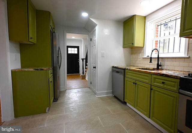 4504 Clay St NE, Washington, DC 20019 - kitchen with green cabinets, a sink, stainless steel appliances, recessed lighting, and decorative backsplash