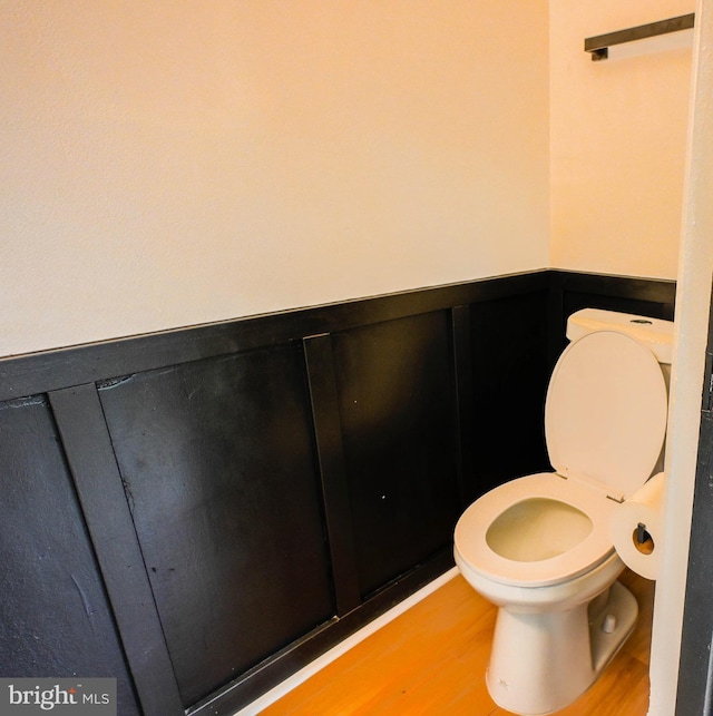 4504 Clay St NE, Washington, DC 20019 - bathroom featuring toilet, wood finished floors, and a wainscoted wall