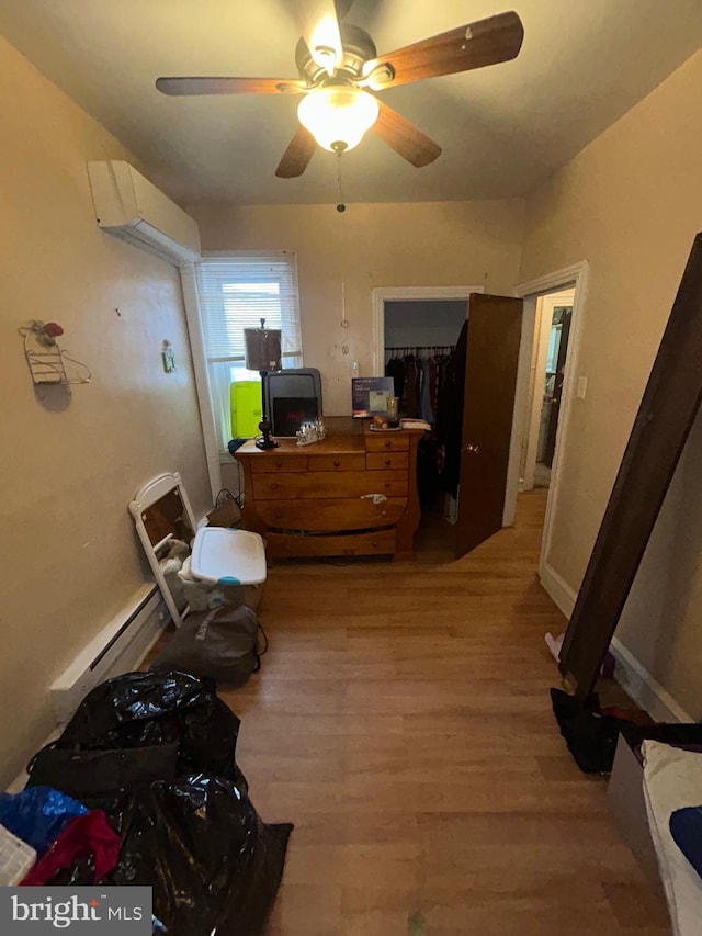 2844 N Hancock St, Philadelphia, PA 19133 - bedroom with light wood finished floors, a wall unit AC, and a ceiling fan