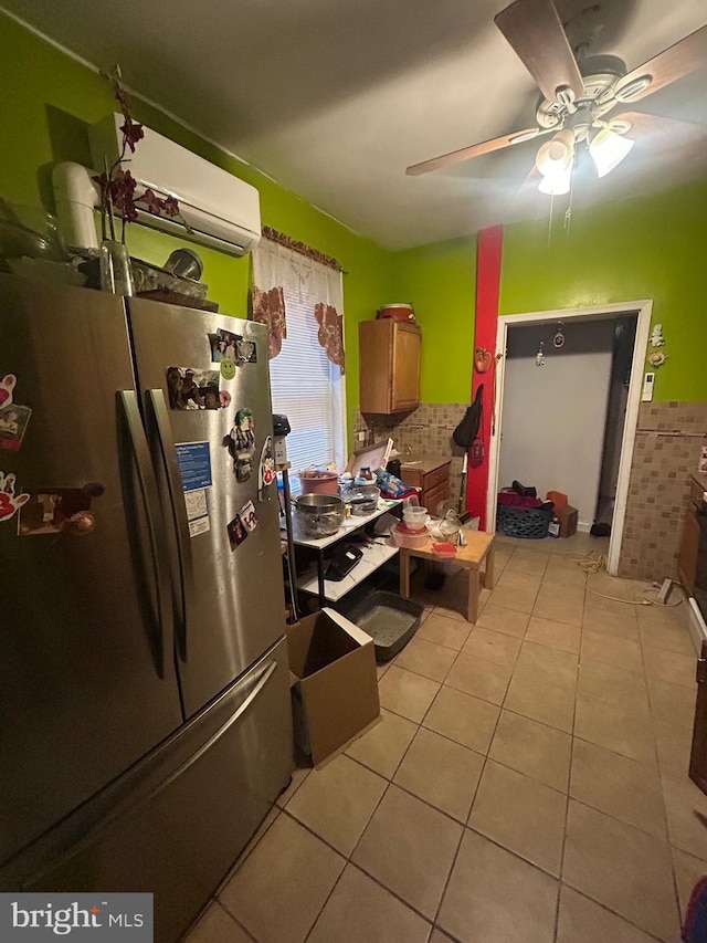 2844 N Hancock St, Philadelphia, PA 19133 - kitchen with freestanding refrigerator, a wall mounted AC, light tile patterned flooring, and a ceiling fan