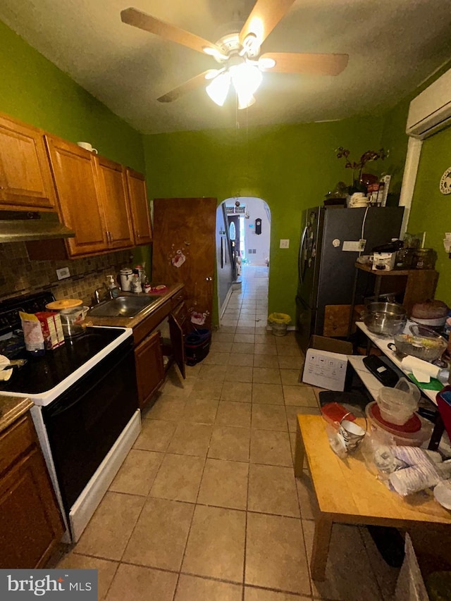 2844 N Hancock St, Philadelphia, PA 19133 - kitchen with electric range, a sink, arched walkways, under cabinet range hood, and ceiling fan