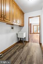 401 Fulton St, Hanover, PA 17331 - washroom with wood finished floors, hookup for a washing machine, cabinet space, and baseboards