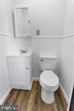 401 Fulton St, Hanover, PA 17331 - bathroom with toilet, vanity, wood finished floors, and baseboards