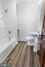 401 Fulton St, Hanover, PA 17331 - bathroom with wood finished floors, shower / tub combination, and toilet