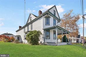 401 Fulton St, Hanover, PA 17331 - back of house with a yard, a chimney, and covered porch