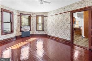401 Fulton St, Hanover, PA 17331 - unfurnished room featuring wood finished floors, wallpapered walls, ceiling fan, and baseboards