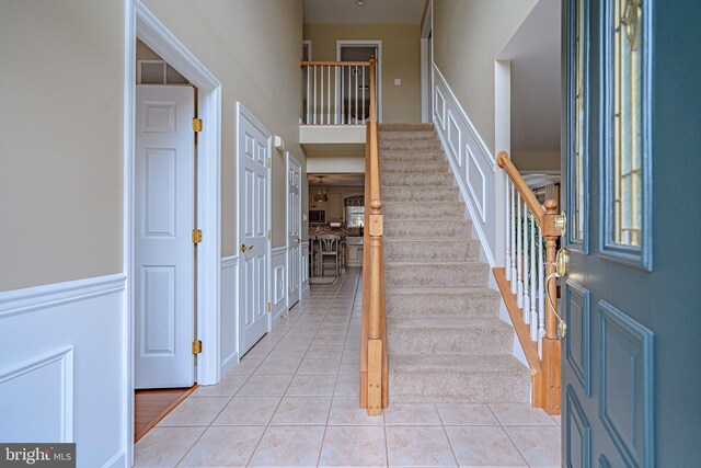 4408 Irish Creek Rd, Bernville, PA 19506 - foyer entrance with stairs, light tile patterned flooring, a wainscoted wall, and a high ceiling
