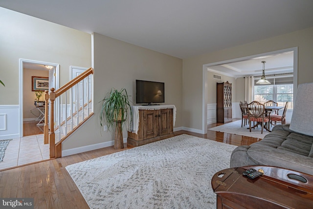 4408 Irish Creek Rd, Bernville, PA 19506 - living room with hardwood / wood-style floors, stairs, and wainscoting