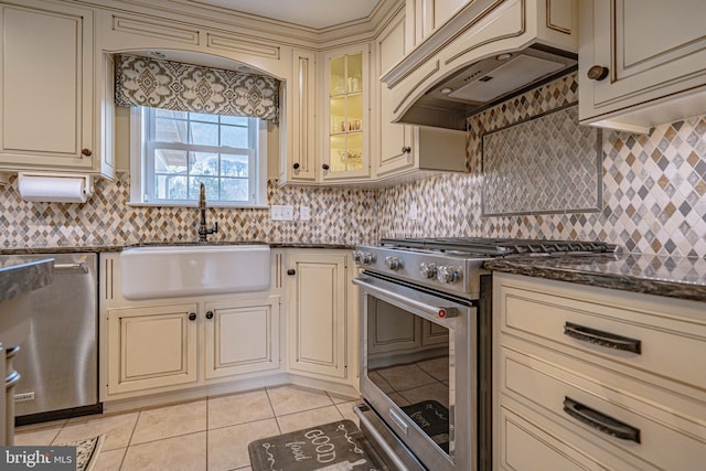 4408 Irish Creek Rd, Bernville, PA 19506 - kitchen with cream cabinetry, appliances with stainless steel finishes, a sink, custom range hood, and light tile patterned floors