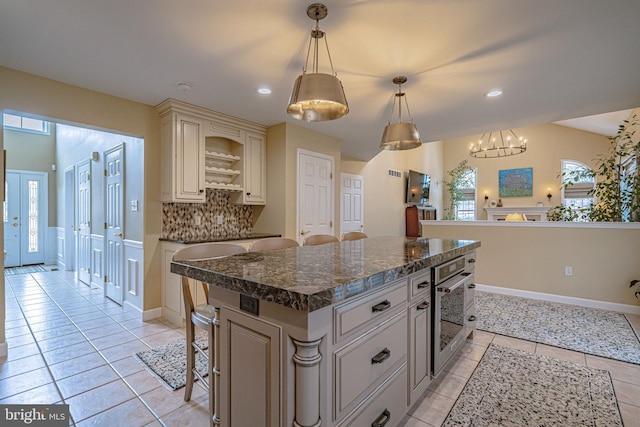 4408 Irish Creek Rd, Bernville, PA 19506 - kitchen featuring cream cabinets, stainless steel oven, tasteful backsplash, light tile patterned floors, and a chandelier