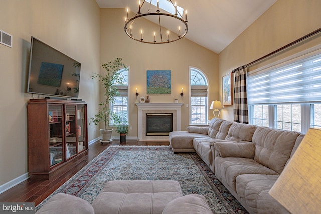 4408 Irish Creek Rd, Bernville, PA 19506 - living area featuring a chandelier, high vaulted ceiling, wood finished floors, a glass covered fireplace, and baseboards