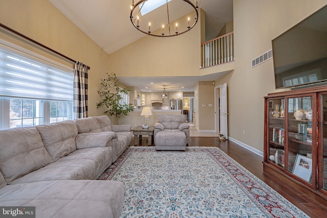 4408 Irish Creek Rd, Bernville, PA 19506 - living area featuring dark wood-style floors, a chandelier, baseboards, and high vaulted ceiling