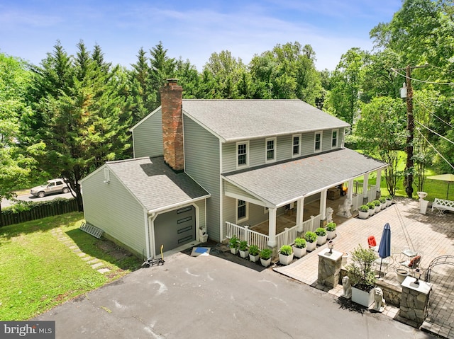10401 Zion Dr, Fairfax, VA 22032 - view of front facade with a shingled roof, a chimney, asphalt driveway, and a garage