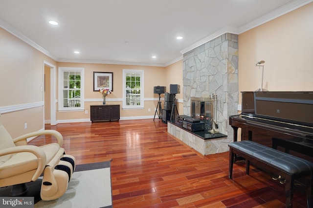 10401 Zion Dr, Fairfax, VA 22032 - living room with wood finished floors, crown molding, a stone fireplace, recessed lighting, and baseboards