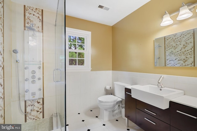 10401 Zion Dr, Fairfax, VA 22032 - full bath with vanity, tile walls, a stall shower, toilet, and tile patterned flooring