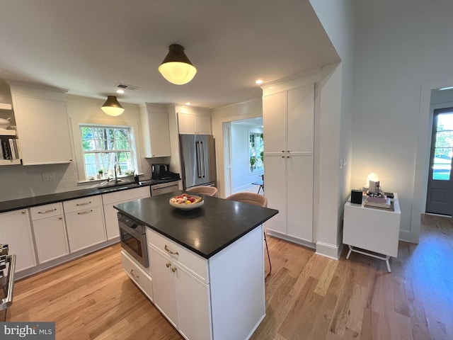 3200 Winnett Rd, Chevy Chase, MD 20815 - kitchen with stainless steel appliances, dark countertops, plenty of natural light, and white cabinets