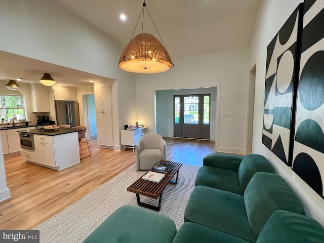 3200 Winnett Rd, Chevy Chase, MD 20815 - living room with light wood-style flooring, healthy amount of natural light, high vaulted ceiling, and french doors