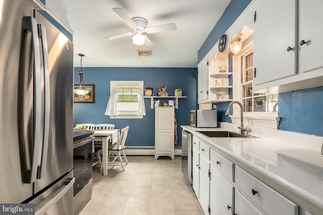 1110 Holland Ave, Cambridge, MD 21613 - kitchen featuring stainless steel appliances, open shelves, a sink, a ceiling fan, and light countertops