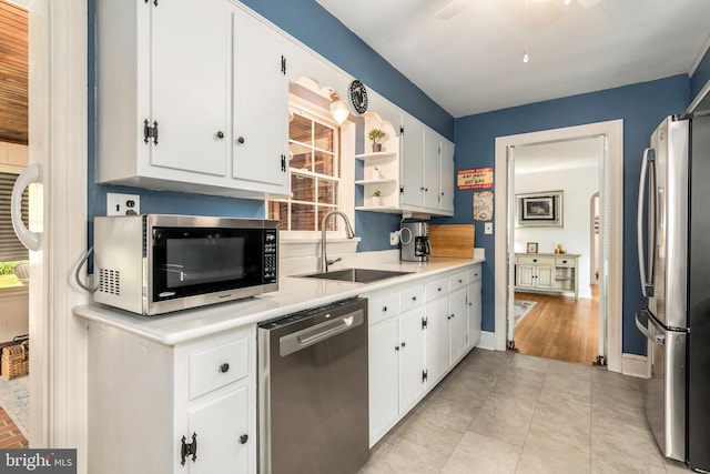 1110 Holland Ave, Cambridge, MD 21613 - kitchen with stainless steel appliances, a sink, white cabinetry, and light countertops