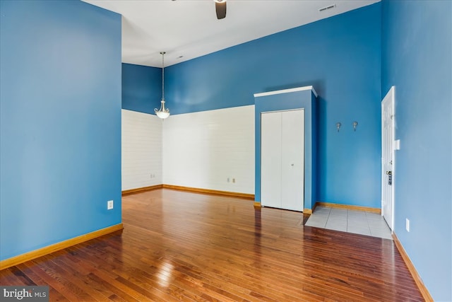 109 Water Fountain Way Unit 304, Glen Burnie, MD 21060 - empty room with ceiling fan, hardwood / wood-style flooring, a towering ceiling, and baseboards