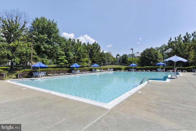 109 Water Fountain Way Unit 304, Glen Burnie, MD 21060 - community pool featuring a patio area and view of wooded area