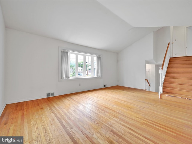 1122 Sheffield Dr, Berwyn, PA 19312 - unfurnished living room featuring wood finished floors, vaulted ceiling, stairs, and baseboards