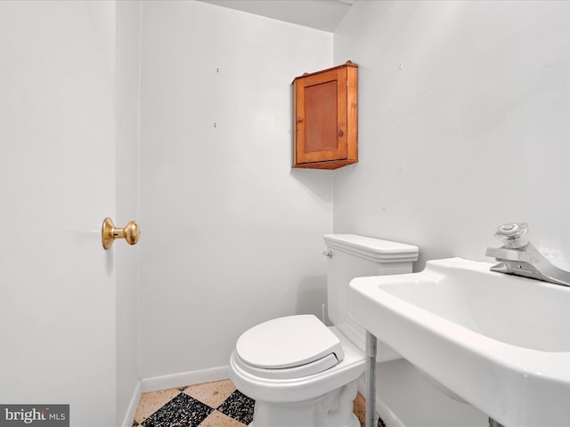 1122 Sheffield Dr, Berwyn, PA 19312 - half bath featuring baseboards, toilet, a sink, and speckle patterned floor